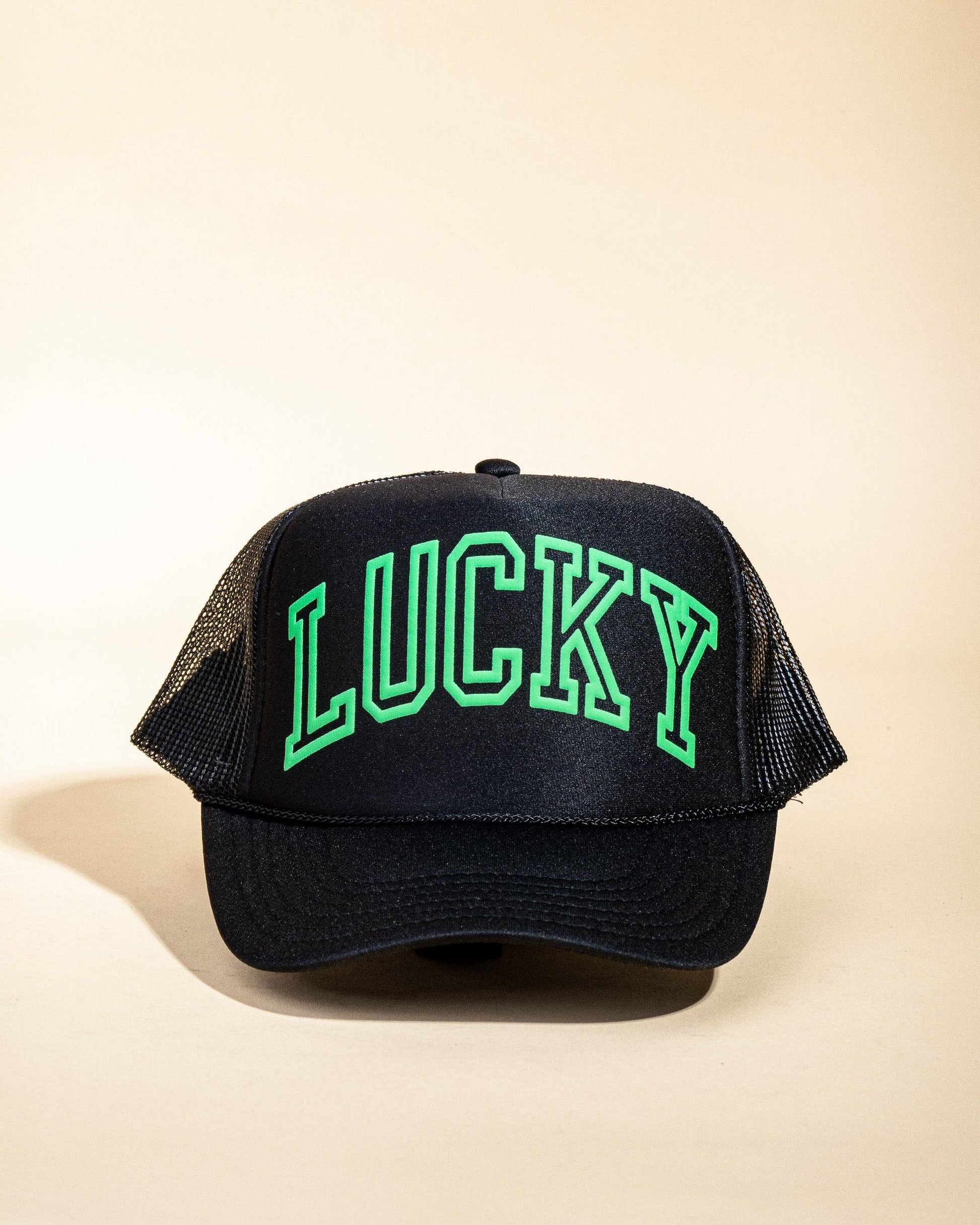 Ascot + Hart Lucky Trucker hat featuring a classic design with adjustable strap and embroidered logo, worn for casual style.