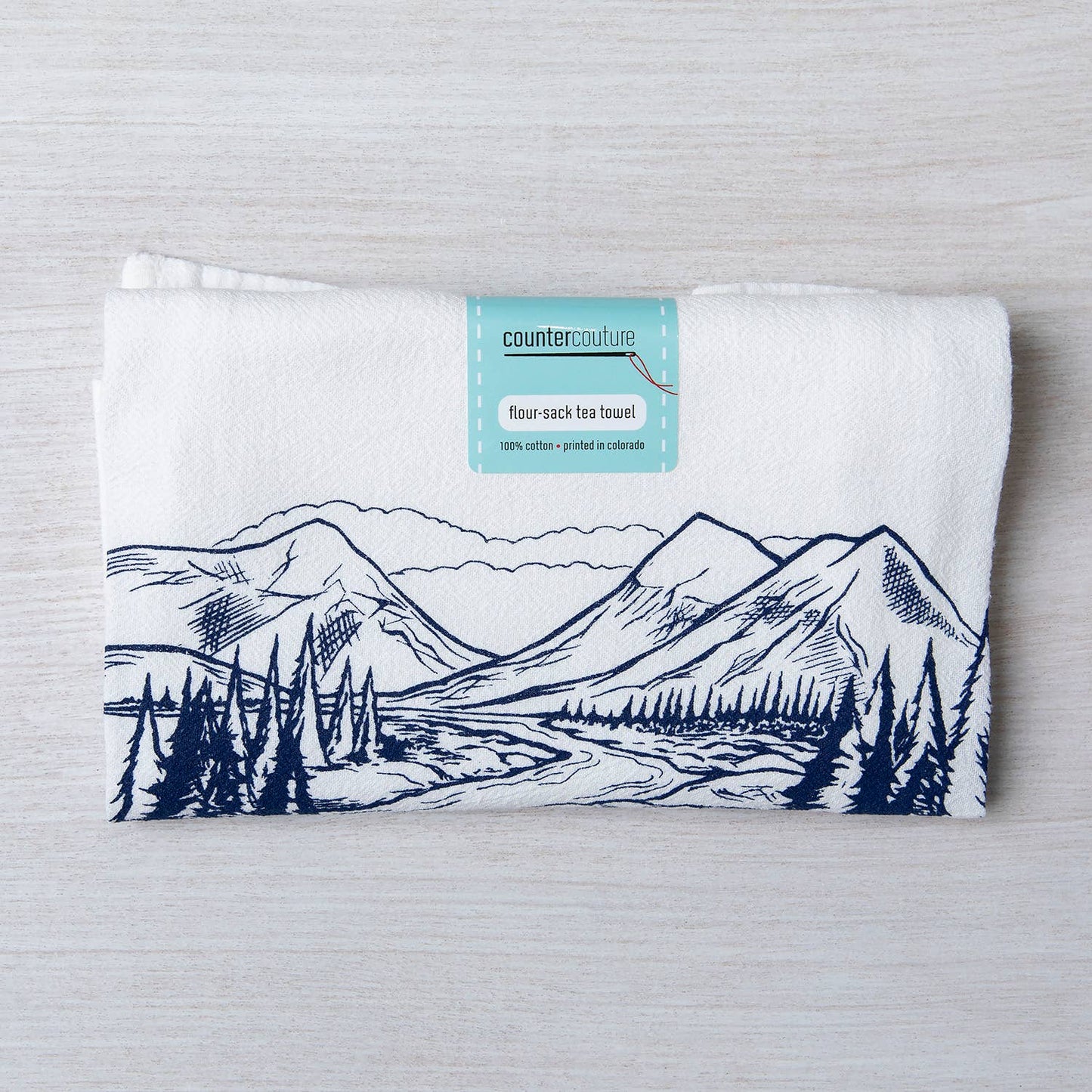 Screen printed mountain tea towel by Counter Couture, made in USA, featuring a detailed mountain landscape design for kitchen decor.