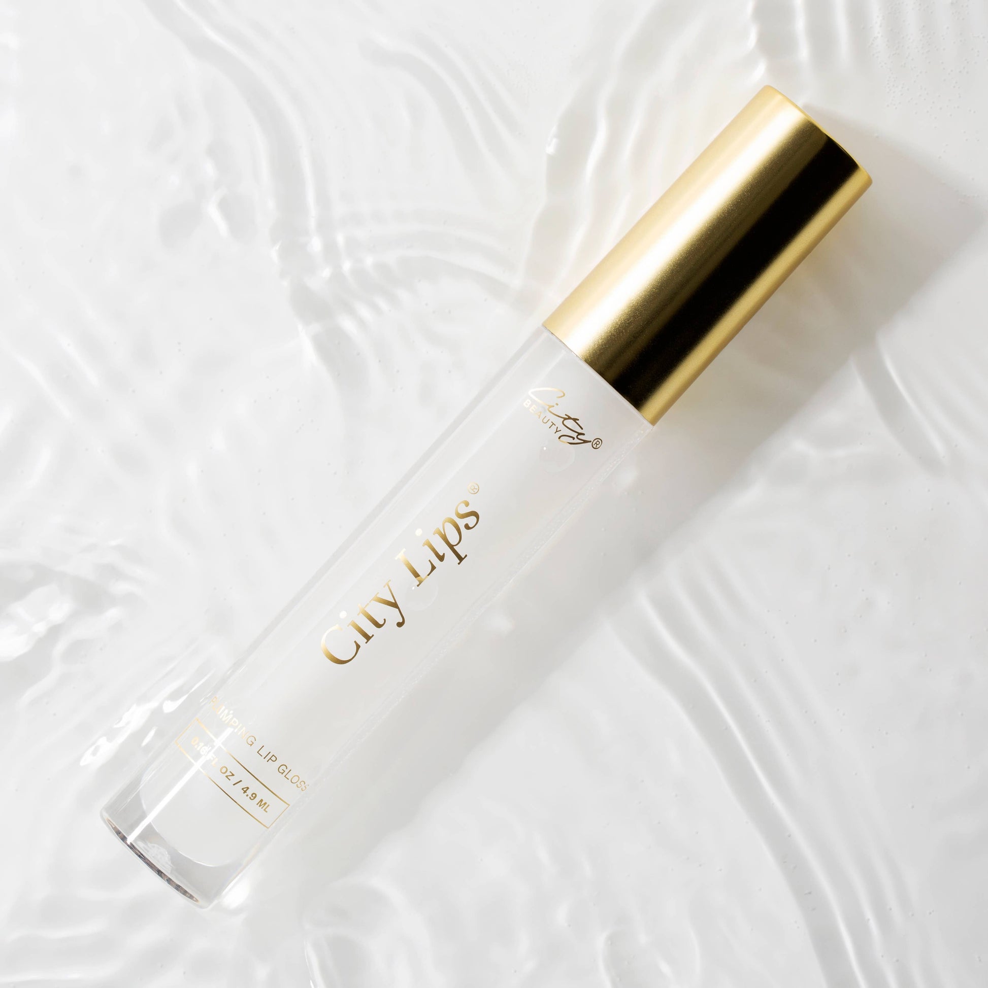 City Lips® Clear plumping lip gloss applied on lips, showcasing glossy, smooth finish with a hint of shine.
