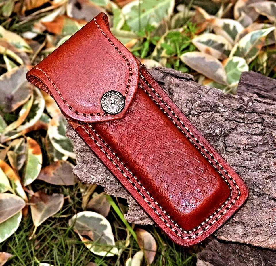 Handmade Damascus Red and Black Wood folding knife by Liconte LLC, featuring a polished blade and intricately crafted wooden handle.