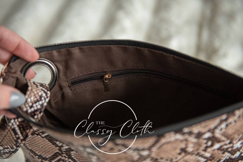 Brown snakeskin clutch bag by The Classy Cloth WS, stylish and trendy with a sleek design and textured exterior.