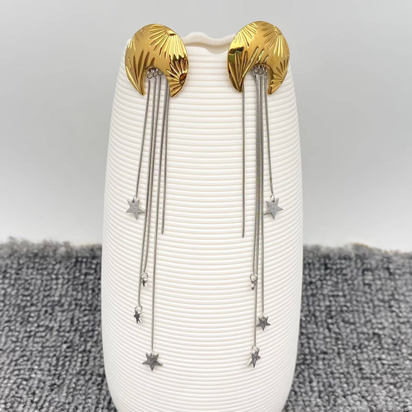 Mio Queena Star Fringe Moon Earrings featuring silver-tone hoops with star and moon charms and fringe detailing.