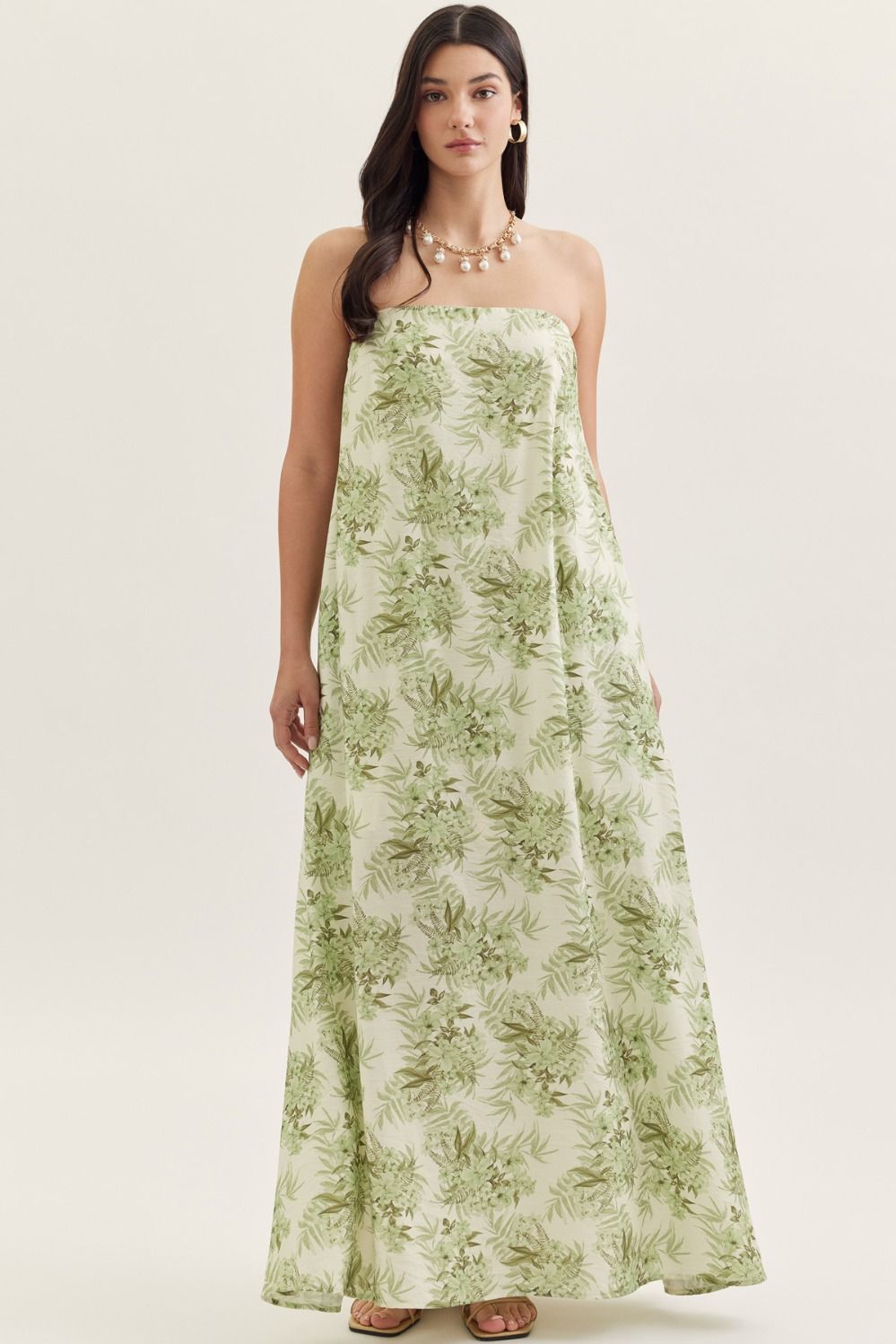 Princess & Buck Fern Gully Dress displayed on a hanger with lush green fern fabric and flowing silhouette.