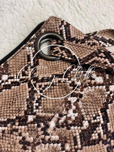 Brown snakeskin trendy clutch bag by The Classy Cloth WS, showcasing sleek design and textured snakeskin pattern.