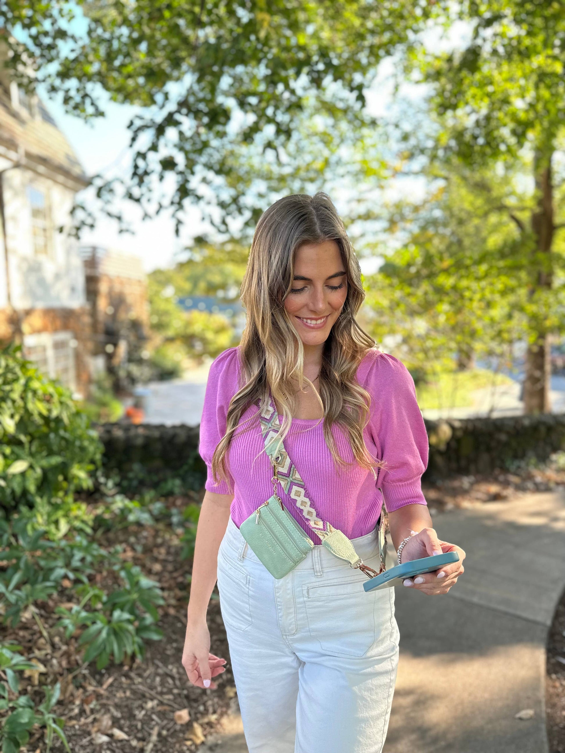 Save The Girls Clip & Go Crossbody Strap with zippered pouch for phones, featuring a stylish, functional design with adjustable strap.