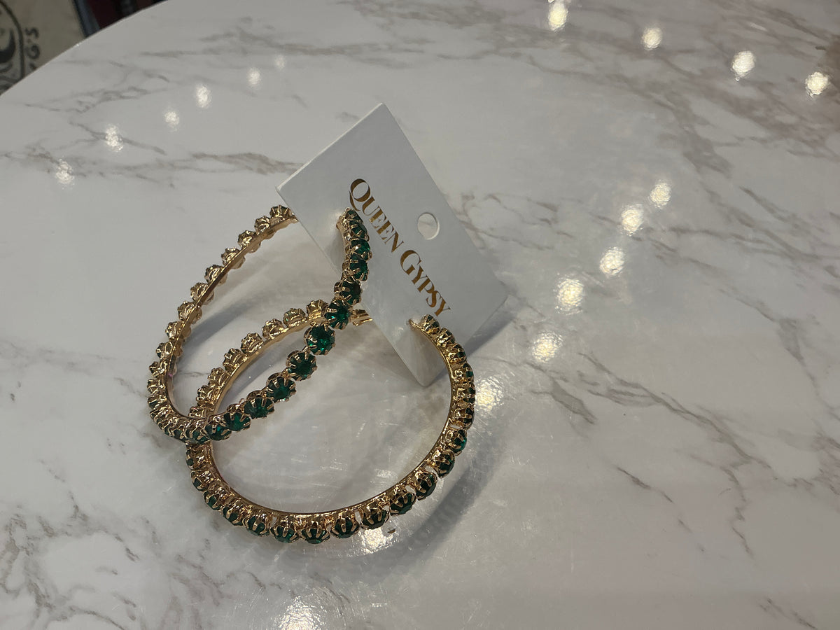 Gold hoop earrings by Queen Gypsy with green crystals, featuring a stylish and elegant design.