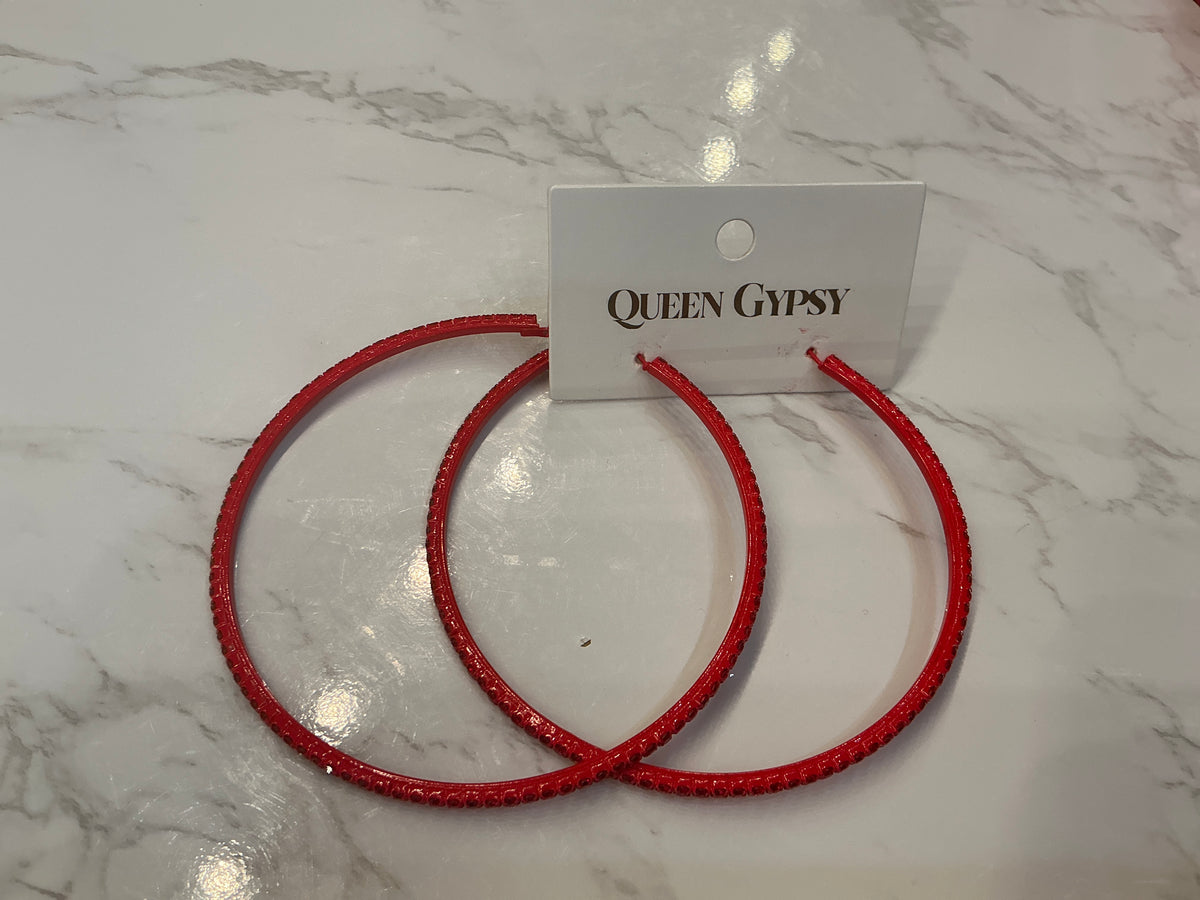 Large red crystal hoop earrings by Queen Gypsy featuring bold red hoops with sparkling crystal accents.