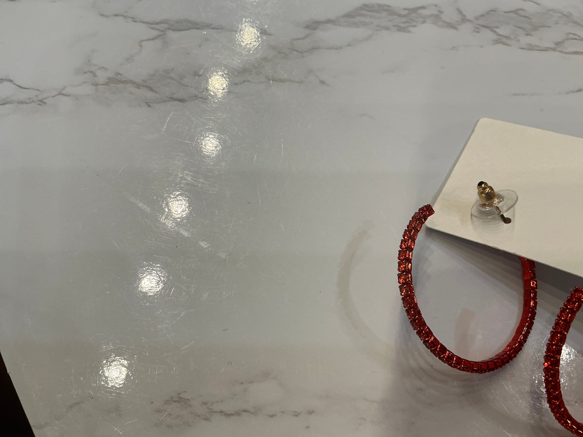 Red crystal hoop earrings by Queen Gypsy featuring sparkling red crystals and classic hoop design.