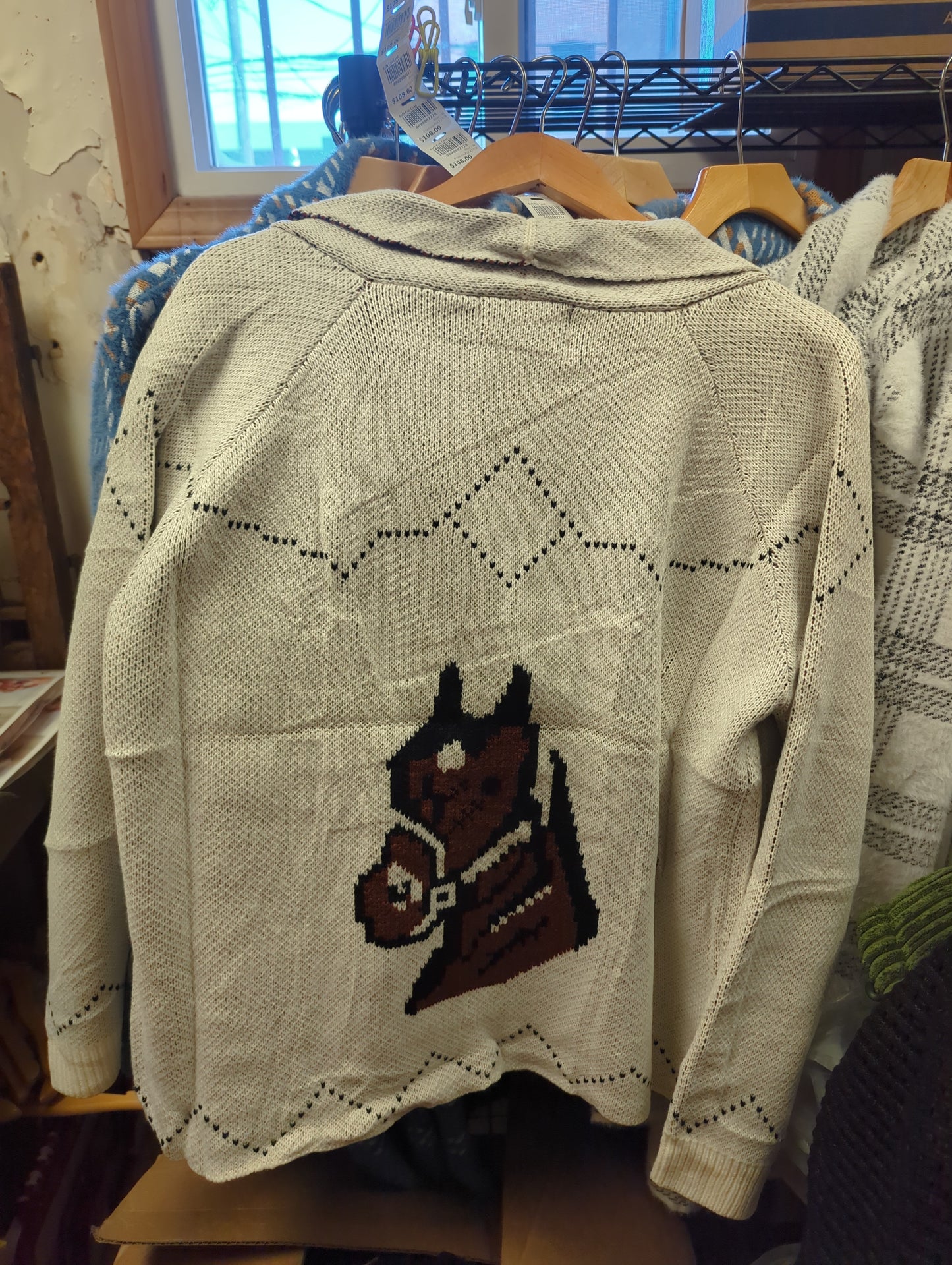 Ivory horse-patterned cardigan sweater by Panache Apparel Co. featuring a cozy knit design and button closure.