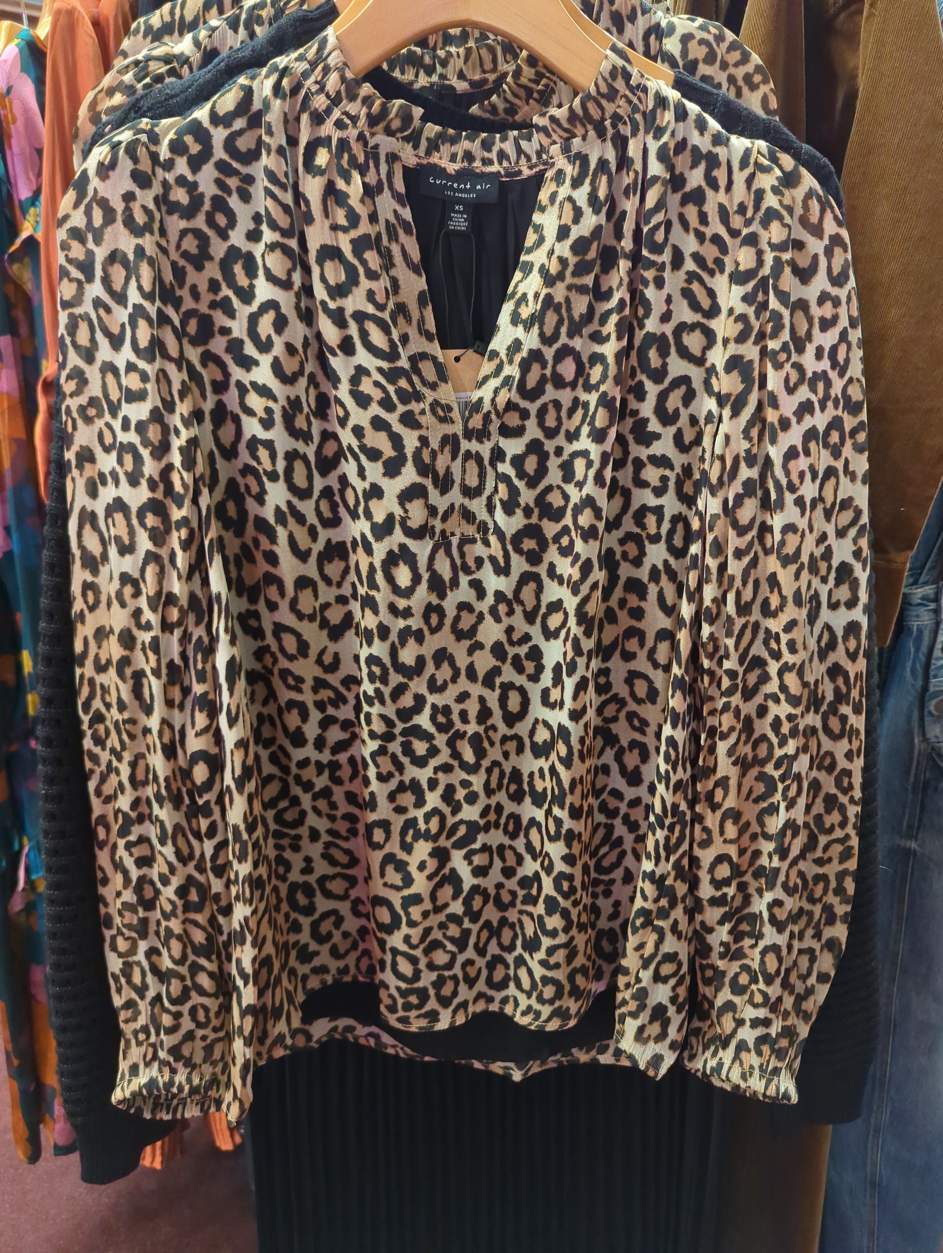 Black gold leopard blouse by Current Air, stylish tops with a bold animal print and elegant design, shown on a model.