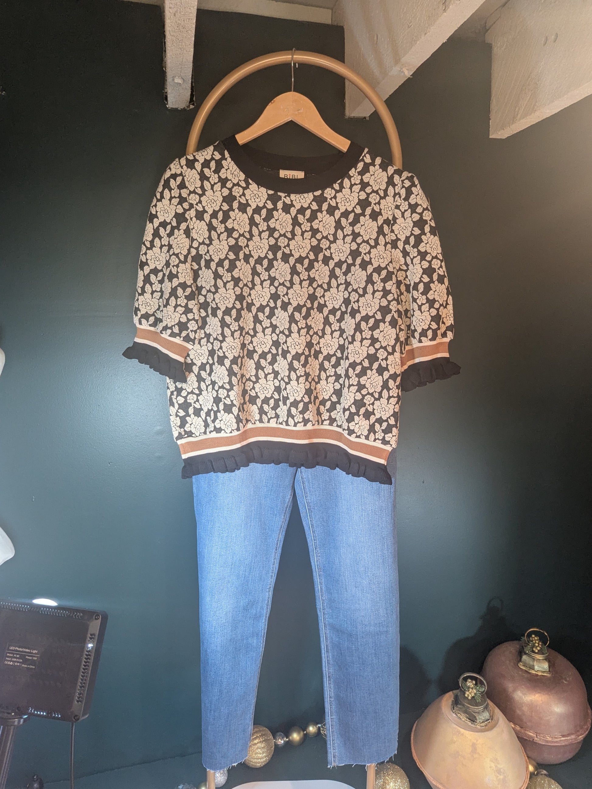 Pink "A Rose is a Rose" sweater by BiBi featuring a floral rose design on soft knit fabric.