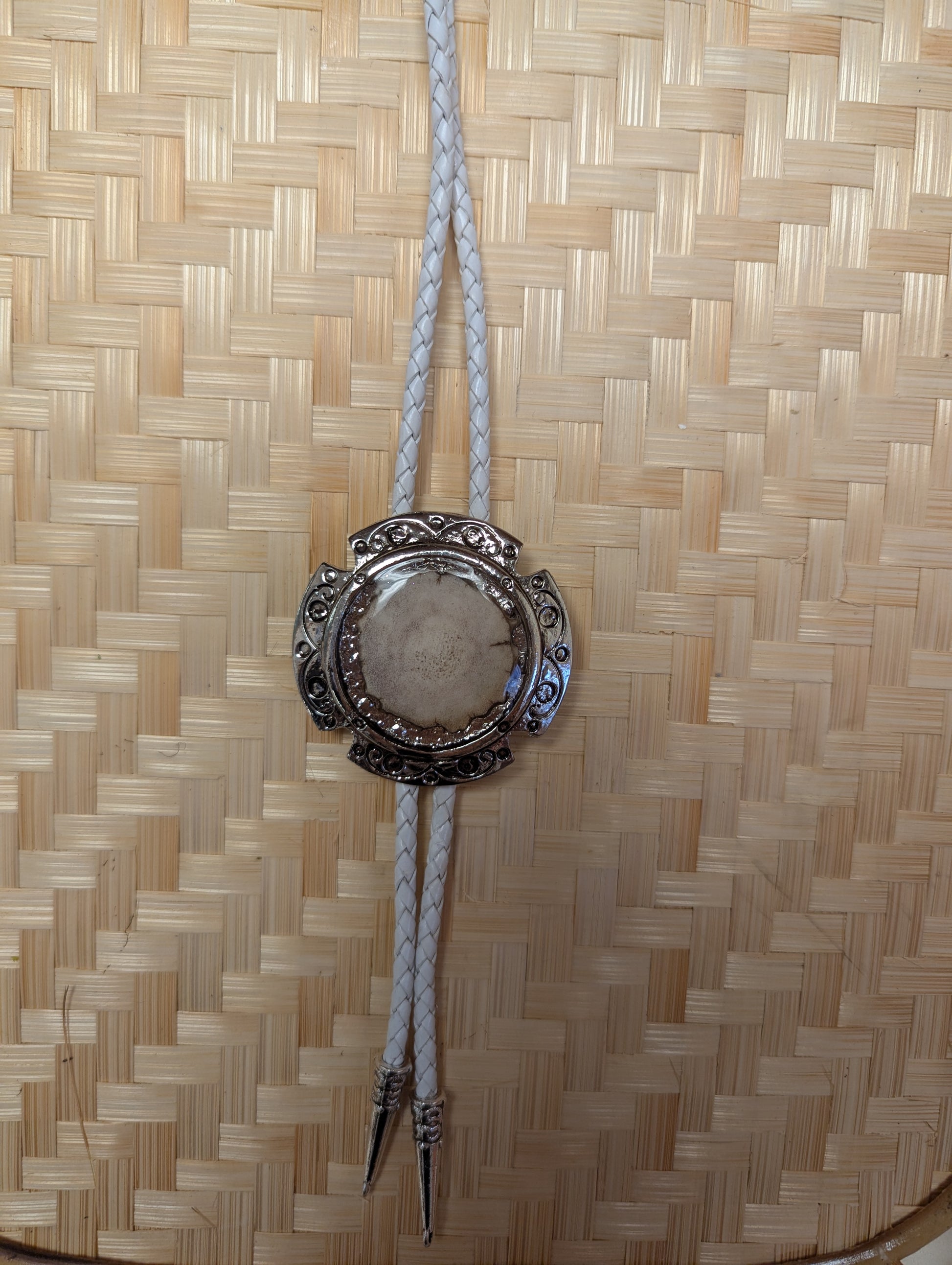 BadAssBabe Badass Bolo Tie with intricate silver-tone design and cord, stylish western accessory for men and women.