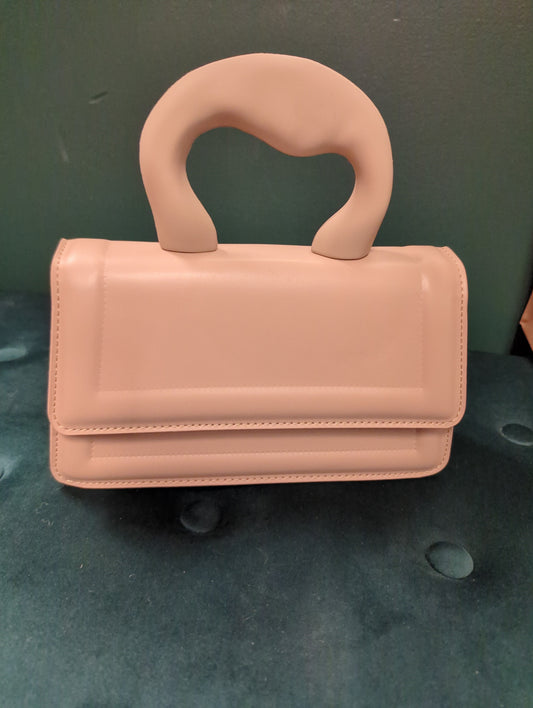 Joia brass knuckles clutch bag with metallic finish and bold design, perfect for statement accessories and evening outings.