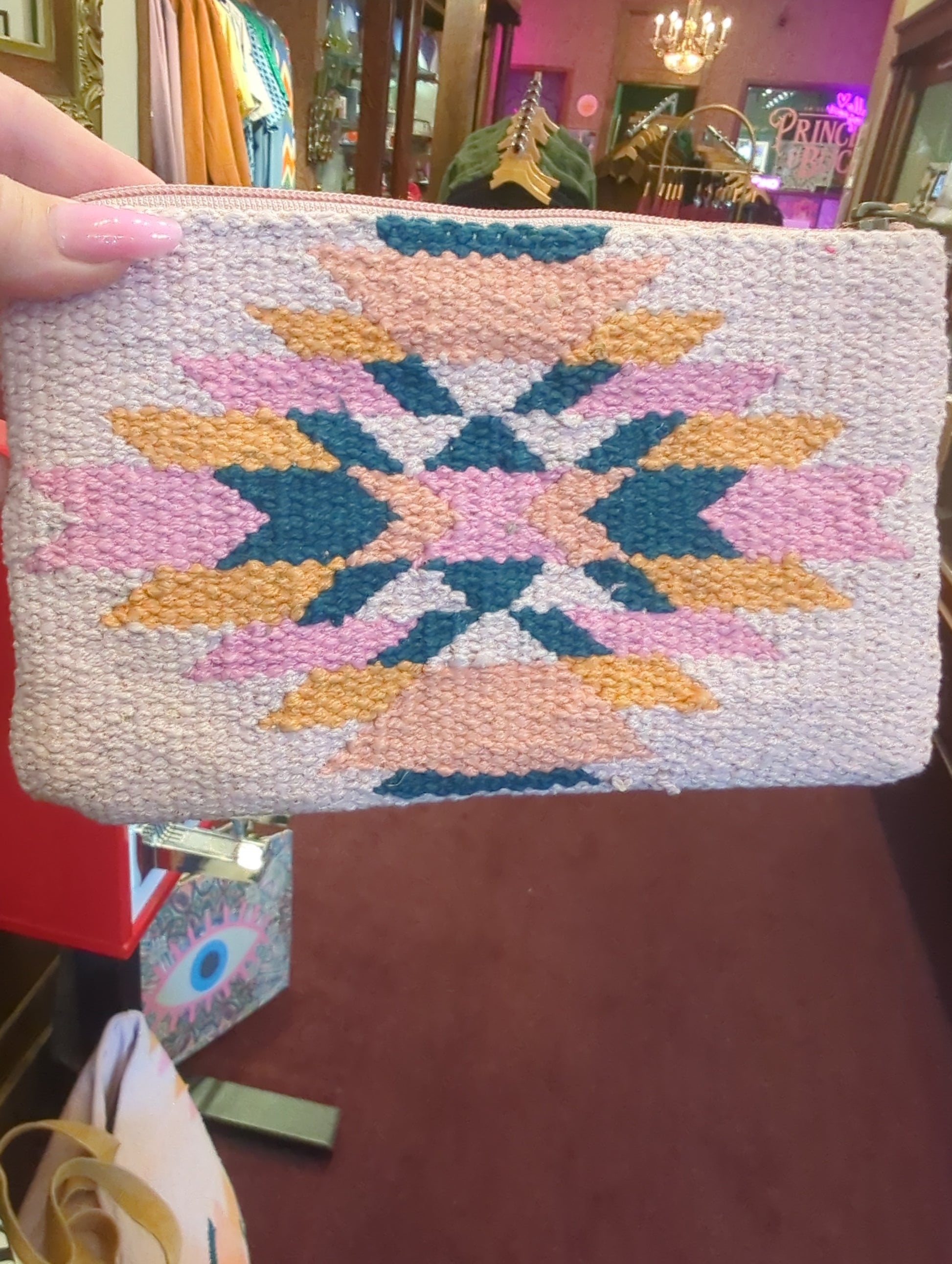 Pink and orange Aztec wristlet bag by Panache Apparel Co. with woven fabric and wrist strap, perfect for casual outings.
