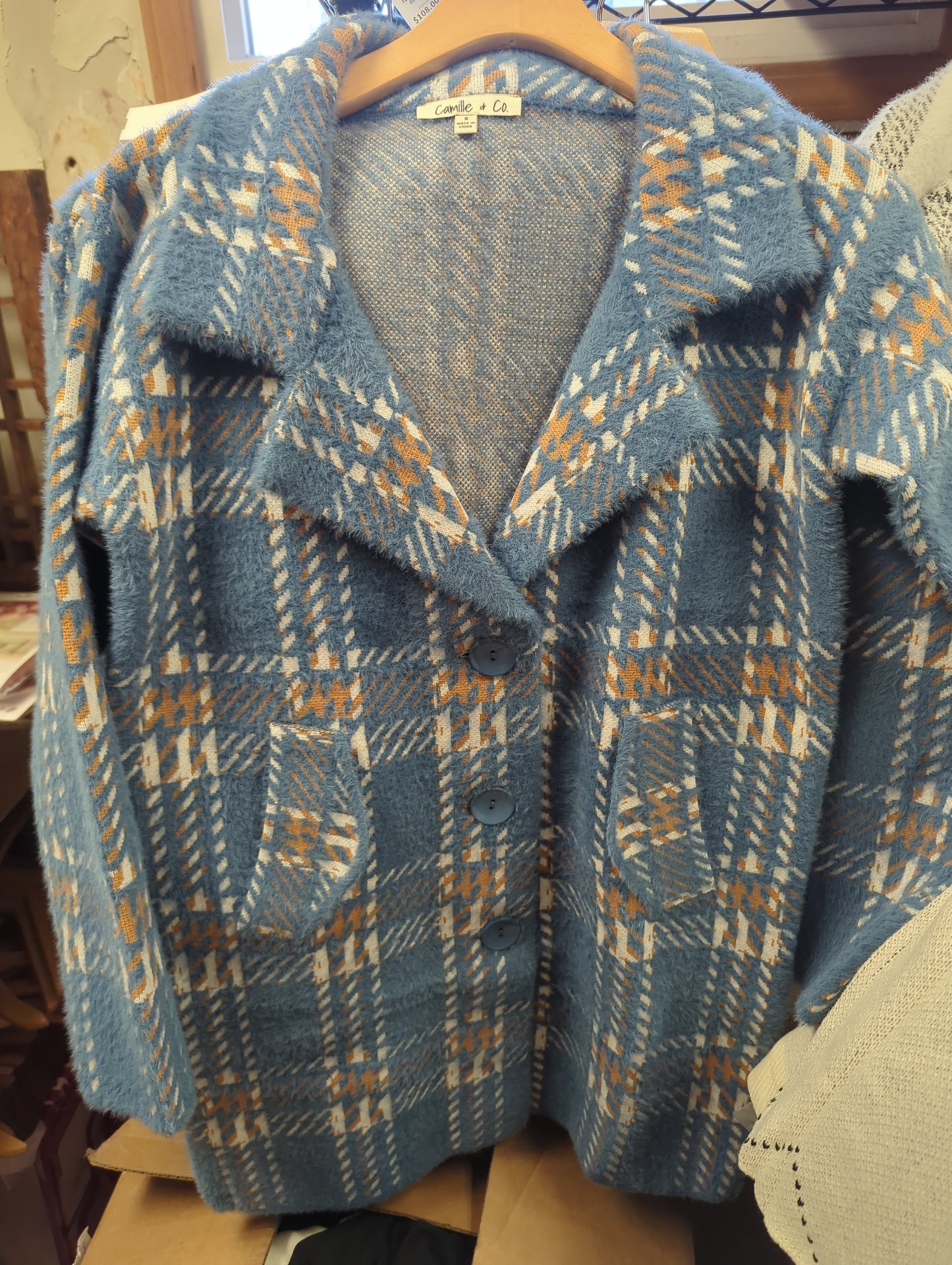 Camille & Co. soft car coat jacket in neutral fabric, displayed on a hanger with a folded collar and long sleeves.