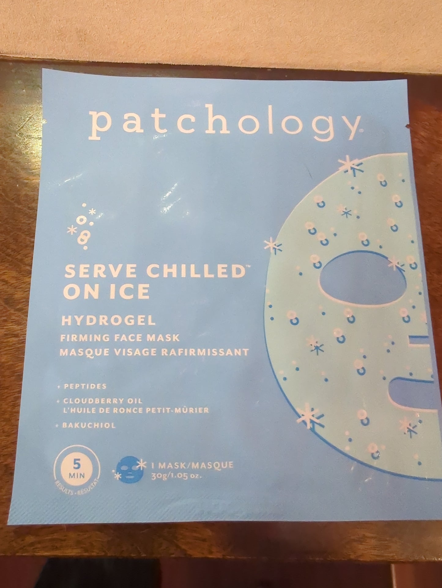 Patchology Serve Chilled On Ice Firming Hydrogel Facial Mask, single, showing the cooling hydrogel mask on a model's face.