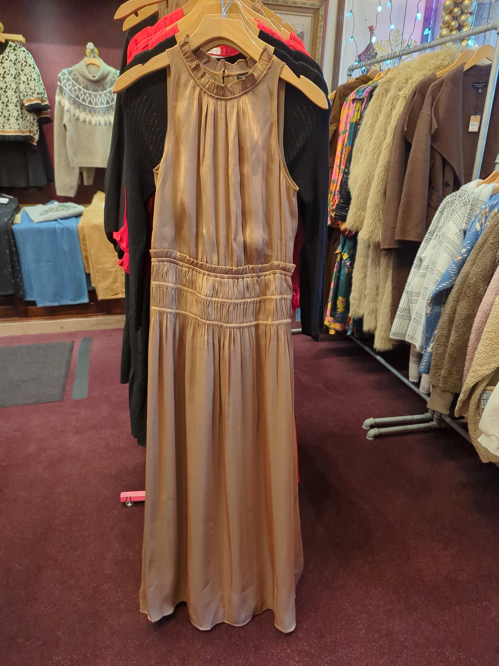 Golden silk halter dress by Current Air featuring a flowing design and elegant draping, perfect for formal occasions.