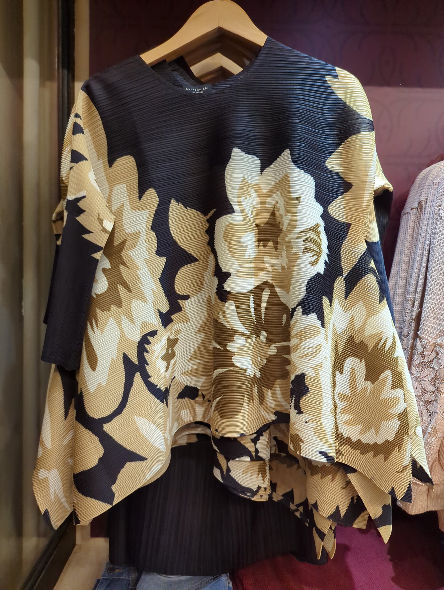 Black and olive pleated top by Current Air featuring a stylish, flowy design and pleated fabric, perfect for casual or dressy occasions.