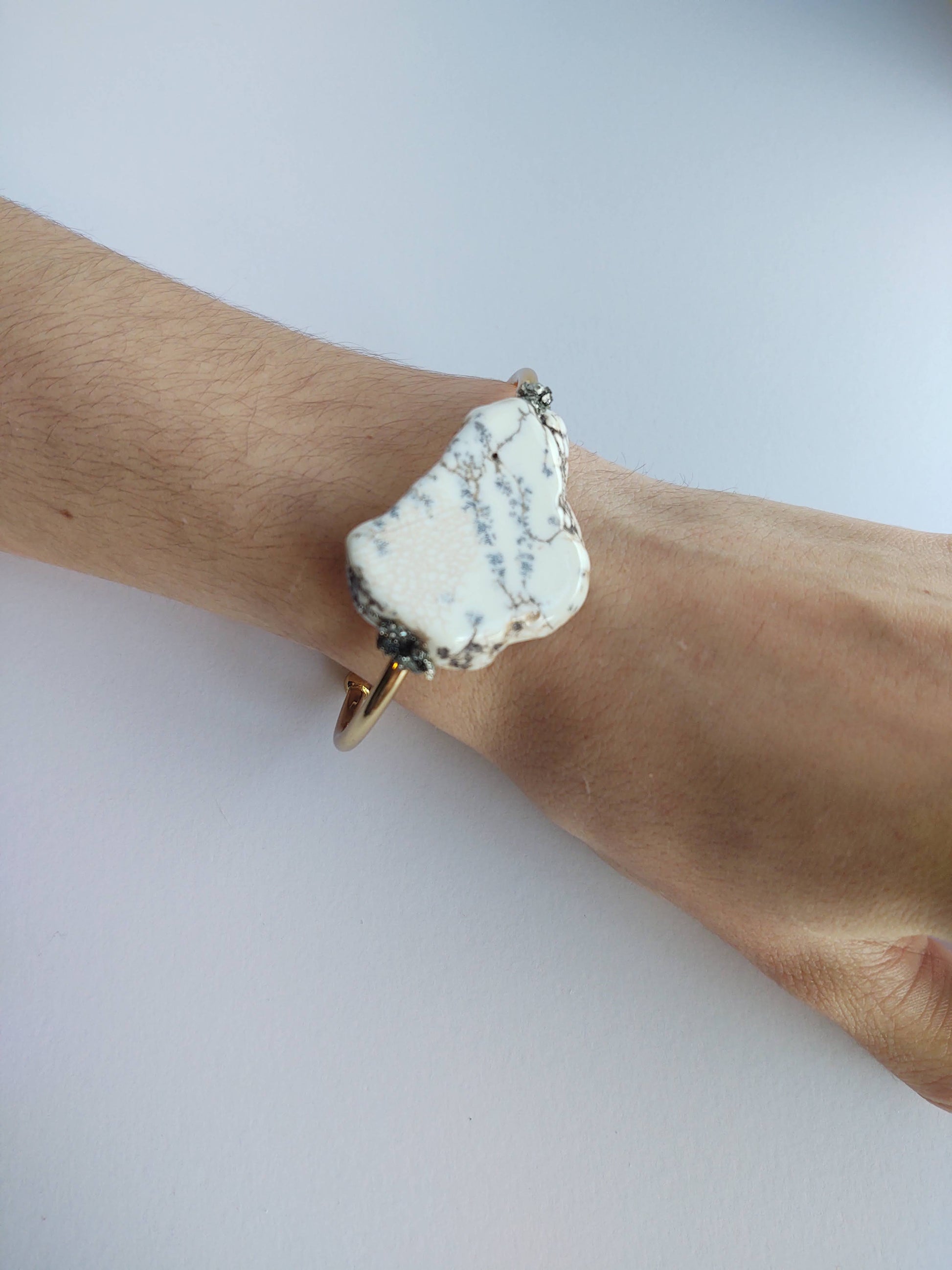 Howlite cuff bracelet by A Sparkling Mess featuring smooth white stone and silver-toned metal accents.